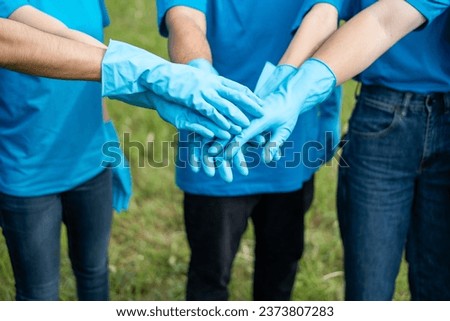 Happy volunteer people group charity with garbage bags cleaning up in park. Corporate social responsibility and society activity for Environment . Ecology and CSR concept. Royalty-Free Stock Photo #2373807283