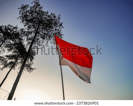 The red and white flag of Indonesian flag with blue sky background