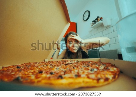 
Woman Looking at the Huge Mind-Blowing Pizza She Ordered. Hungry girl eating a fast food for comfort at home
 Royalty-Free Stock Photo #2373827559