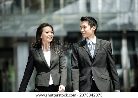 Happy Chinese Business colleagues walking outside office and talking to each other. Royalty-Free Stock Photo #2373842373