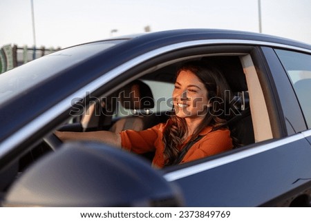 Photo of positive cheerful girl funky driver rider enjoy drive ride car under pop star hits playlist music try dance raise hands in city center Royalty-Free Stock Photo #2373849769