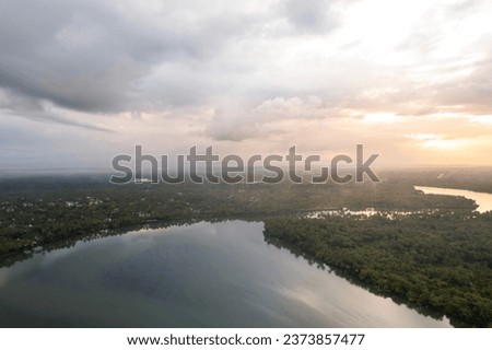 Sunrise view from Kavvayi Island Kannur, Kerala travel and tourism concept image, Aerial view of river with palm trees  Royalty-Free Stock Photo #2373857477