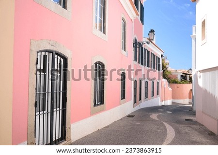 Cascais street and pink house, Portugal Royalty-Free Stock Photo #2373863915