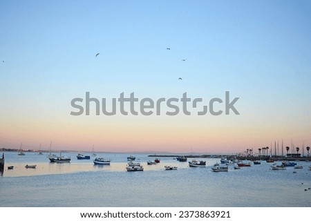 Sunset colours and fishing boats in Cascais, Portugal Royalty-Free Stock Photo #2373863921