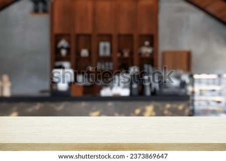 Empty wooden table with blur background of cafe and restaurant.