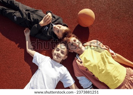 Laid-back Laughter: Unwinding with Children on the Basketball Court Surface