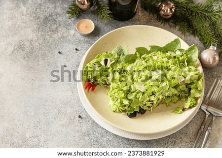 New 2024 - the year of a green dragon, creative design for party. Layered Salad with mushrooms, beans and сhinese cabbage in shape of dragon as symbol of chinese new year. Copy space.