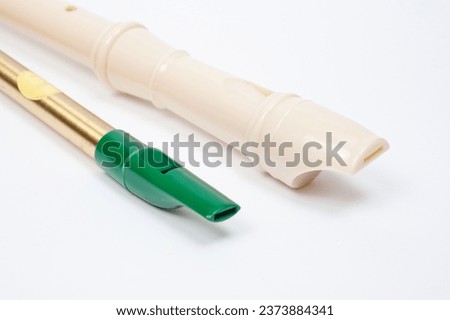 Irish whistle and block flute are longitudinal flutes with a whistle device and playing holes. Royalty-Free Stock Photo #2373884341