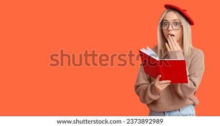 Beautiful young shocked woman with book on orange background with space for text
