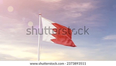 Bahrain national flag waving in beautiful sky. Royalty-Free Stock Photo #2373893511