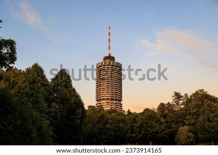 Hotel tower in Augsburg popularly called corncob in Wittelsbacher Park on a summer evening with evening glow Royalty-Free Stock Photo #2373914165