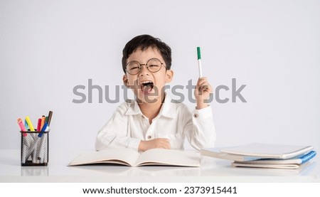 Portrait of an Asian boy studying on a white background