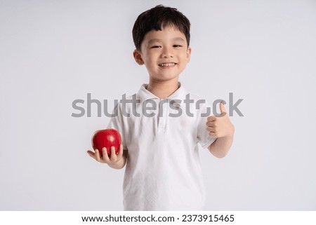 Portrait of asian boy posing on white background Royalty-Free Stock Photo #2373915465
