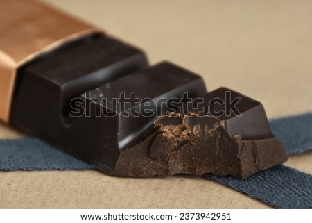 Three-quarter angle of Belgian gourmet chocolate bar with 70% cocoa to crunch with a coffee or on its own.