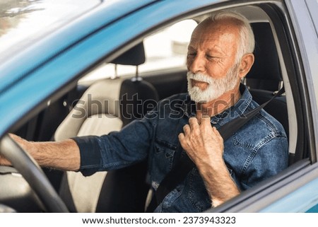 Portrait of smiling mature man driving his car. Close-up of man driving car. 