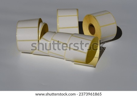 Blank sticky label roll for thermal transfer printing close up white background. Rolls of white labels isolated. Labels for direct thermal or thermal transfer printing. Blank sticky label roll.
