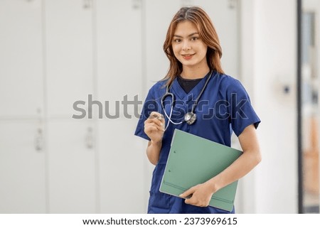 Young Asian nurse or Female medical assistant in clinic Royalty-Free Stock Photo #2373969615