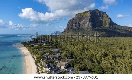 Le Morne tropical beach and famous kite, surf spot aerial panoramic view with palm trees and white sand blue ocean and sunbeds with umbrellas, Mauritius Royalty-Free Stock Photo #2373979601