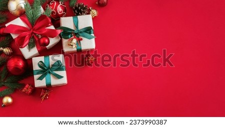 Holiday red background with gift boxes and Christmas decorations. Christmas holiday background. Top view with copy space.