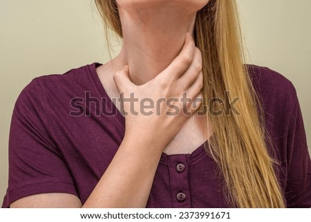 The girl is holding her neck Royalty-Free Stock Photo #2373991671