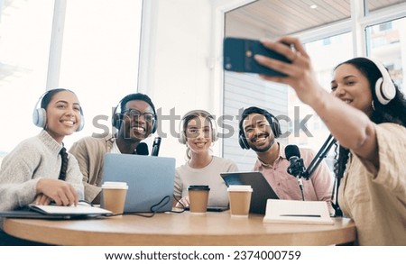 Podcast, happy and group selfie of friends together, live streaming or people recording broadcast on headphones or mic in studio. Smile, team and radio hosts take photo at table for social media blog