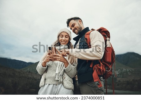 Couple, phone and travel in nature or mountains with hiking information, social media or check for direction on journey. Happy people trekking in backpack, mobile chat or search for outdoor location