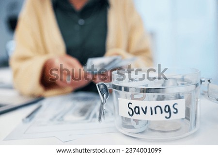 Woman, jar and savings for money, investment or growth in finance, profit or expenses on desk at home. Female person counting cash, bills or paper notes in financial freedom or interest in container Royalty-Free Stock Photo #2374001099