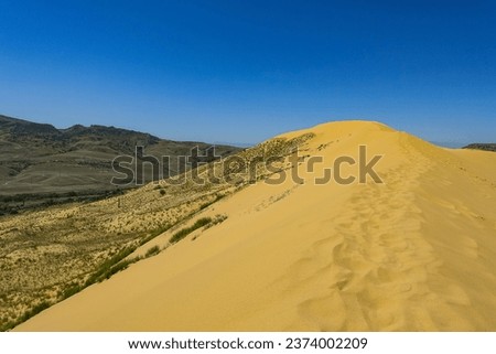 Sand dunes of the Sarykum dune. A natural monument. Dagestan. Royalty-Free Stock Photo #2374002209