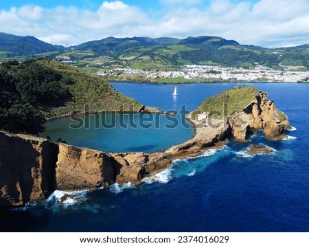 Azores aerial panoranic top view of Islet of Vila Franca do Campo. Sailboat in the ocean.  Crater of old volcano in ocean. San Miguel, Acores, Portugal. Travel concept. Royalty-Free Stock Photo #2374016029