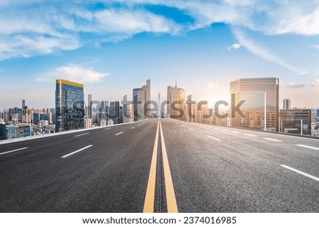 Straight asphalt road and city commercial buildings scenery in Guangzhou, Guangdong Province, China. Royalty-Free Stock Photo #2374016985