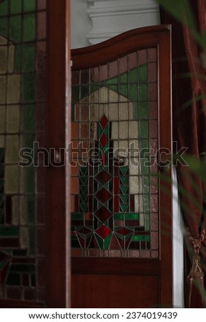 Cowboy door or swing door in a neo-classical style house with attractive old stained glass decoration.