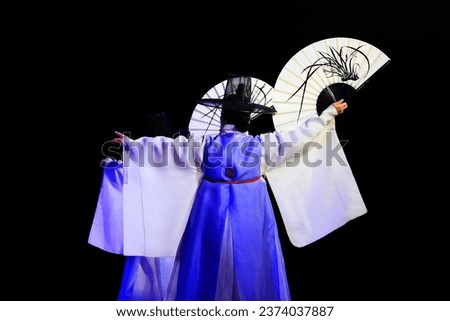 Korean traditional dance of a man holding a fan Royalty-Free Stock Photo #2374037887
