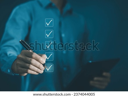 business verify task detail and evaluation tick mark. person ticks the checkmark in the box on the tablet. on the list of documents. concept audit, check form online, checklist process order. Royalty-Free Stock Photo #2374044005