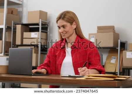Seller with laptop working in office. Online store