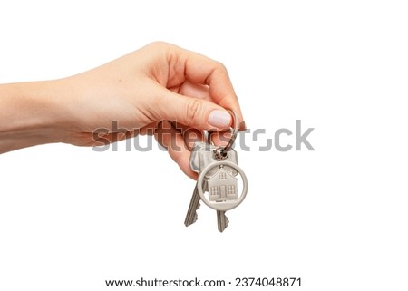 Woman holding house keys with house shaped keychain, isolated on white background Royalty-Free Stock Photo #2374048871