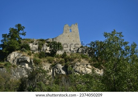 Remains of the Canossa castle located on a cliff in the Reggio Emilia Apennines from which it dominates the valley of the Enza river Royalty-Free Stock Photo #2374050209