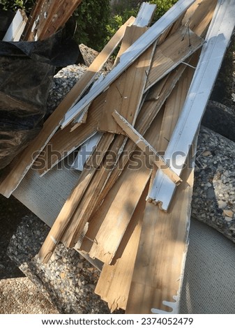 Baseboard removal before installing hardwood flooring; old baseboards and trims Royalty-Free Stock Photo #2374052479