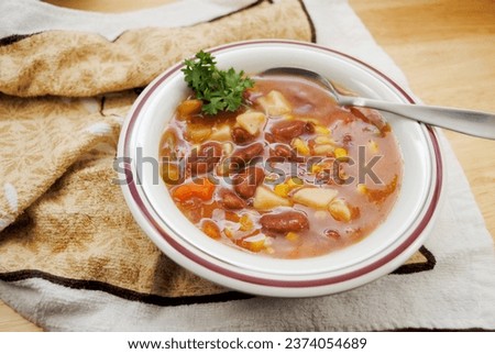 Vegan Garden Vegetable Soup Served in a White Bowl
