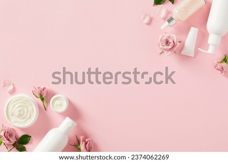 Natural beauty products for body treatment and skin care concept. Flat lay white cosmetic bottles, jars of moisturizer cream, rose buds and petal on light pink background.