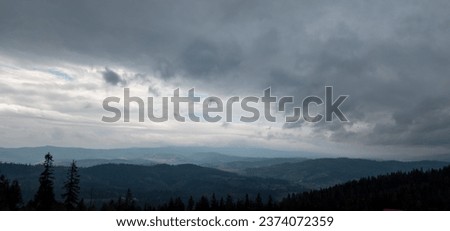 Autumn brings overcast skies adorned with gray stratus clouds, hinting at impending rain. This full-screen view provides ample space for text or design elements, making it perfect for various projects Royalty-Free Stock Photo #2374072359