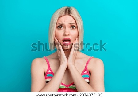 Portrait of young funny girl touch cheeks open mouth staring problems bad news she forgot her id card isolated on blue color background Royalty-Free Stock Photo #2374075193