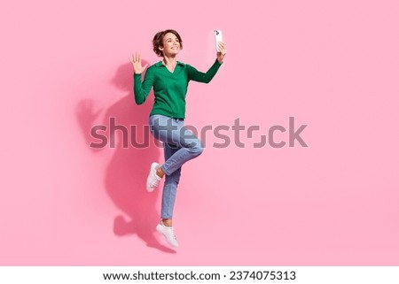 Full length photo of positive young girl waving palm for selfie video call blogger recording fresh content isolated on pink color background