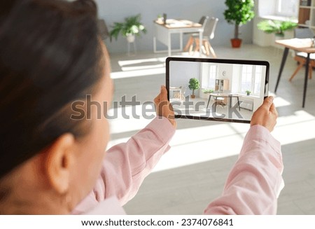 Female real estate agent making virtual tour of office using her digital tablet. Kealtor doing virtual showing for client who wants to rent or buy office space. Real estate photo shoot concept.