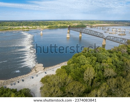 Chain of Rocks on the Mississippi RIver above St Louis with the Low Water Dam, water towers, old historic bridge and the new bridge with construction work Royalty-Free Stock Photo #2374083841