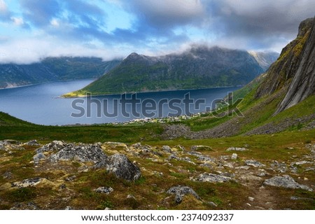 View of the Fjordgard village from Hesten trail to the Segla mountain on Senja island in northern Norway. This village is located in the Oyfjorden at the northwest coast of Senja. Royalty-Free Stock Photo #2374092337