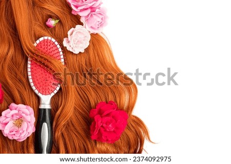 Long wavy red female hair brush, comb. Hairdressing Products, coloring in bright colors. Hair care.