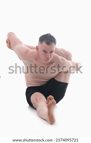 Kapilasana (Kapila pose), Ashtanga yoga  Man wearing sportswear doing Yoga exercise against white background. Vertical image.