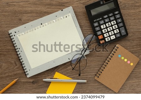 blank notepad with glasses and calculator, top view. space for text on notepad page