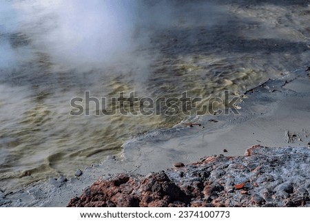Condition of Sikidang Crater up close. You can see the sulfur water boiling and emitting smoke next to the rocks. This crater has become a tourist attraction in Dieng and is a geothermal site.