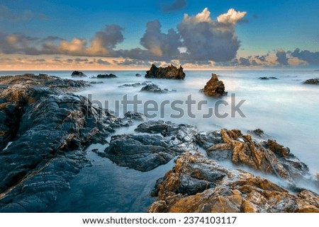 Tropical rocky beach at sunrise ( long exposure photography), Soft effect due to long exposure shot.